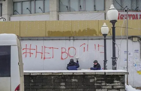 Закрашивают антивоенную надпись / Фото из соцсетей​